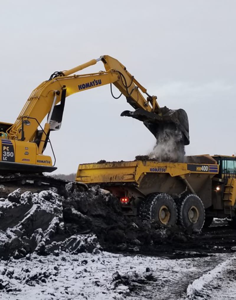 Crawler dumping sand in truck